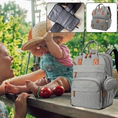 sac a langer nomad bebe sur banc
